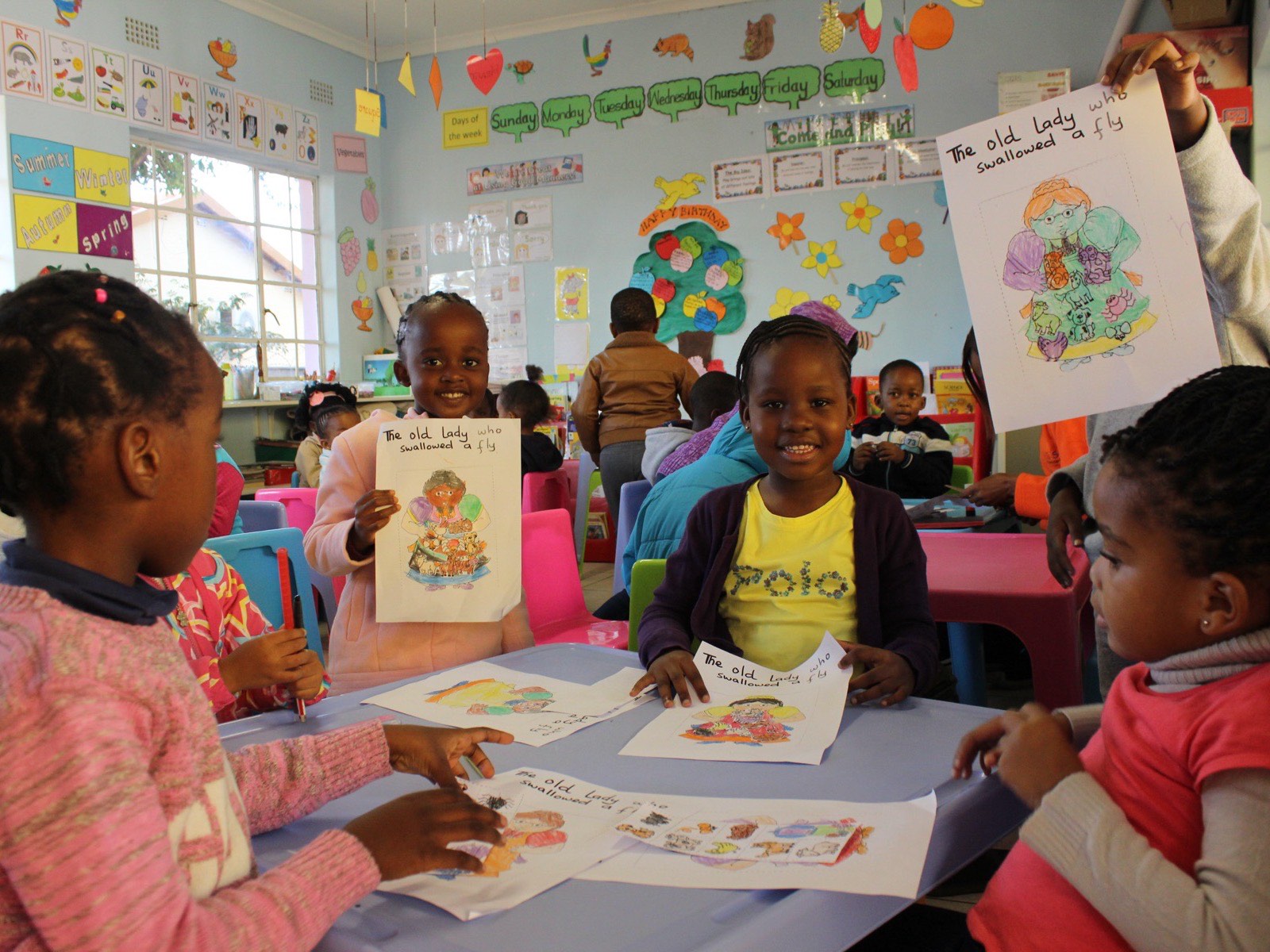 Learners showing their work during a classroom activity at Hibiscus Schools