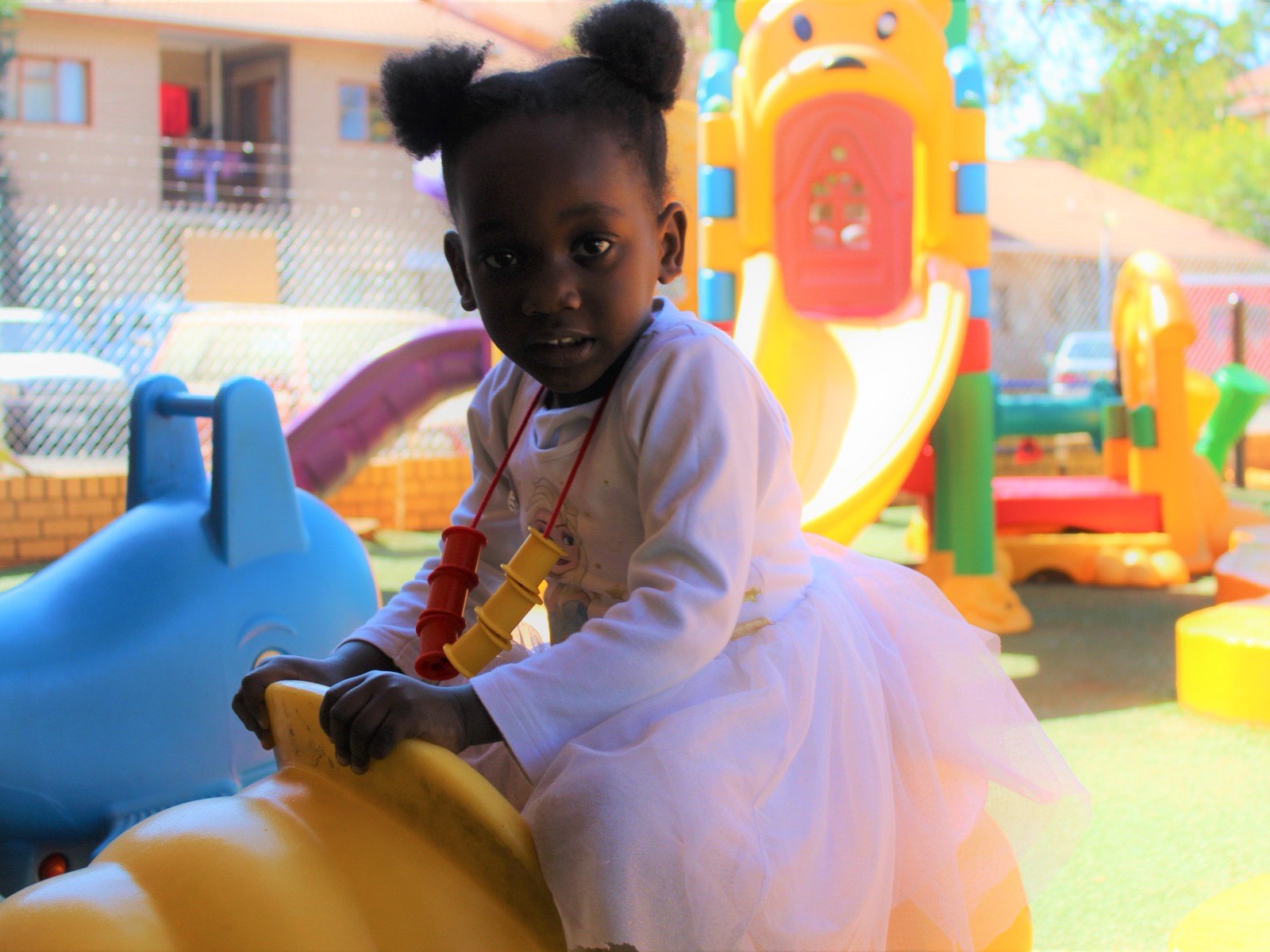 A young learner on the playground at a Hibiscus day care in Gaborone